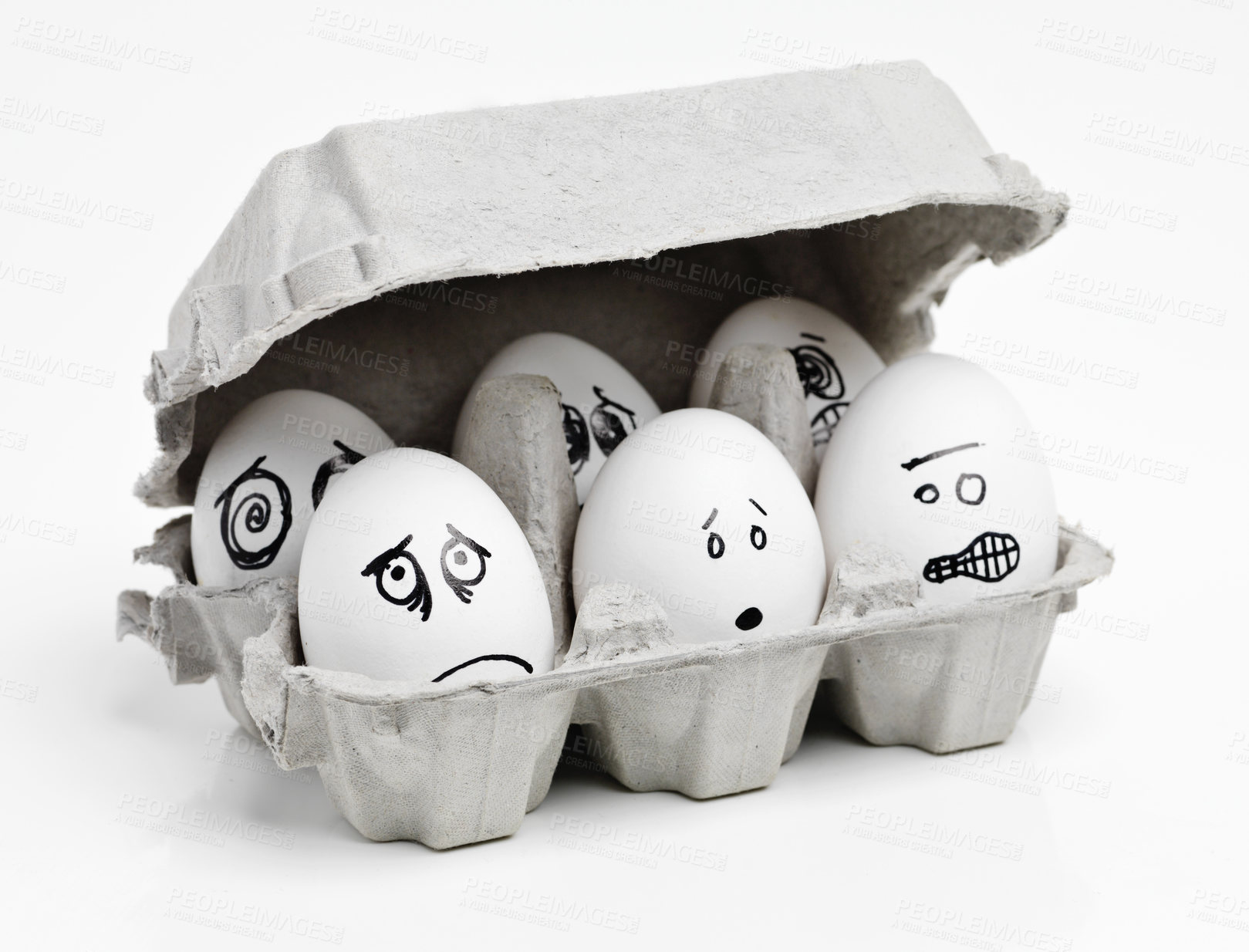 Buy stock photo Studio shot of faces drawn onto a carton of eggs