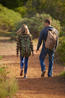 Buy stock photo Path, hiking and happy couple walking in nature for holiday, travel or adventure outdoor with backpack. Rear view, man and woman trekking in the countryside on vacation, journey and date together