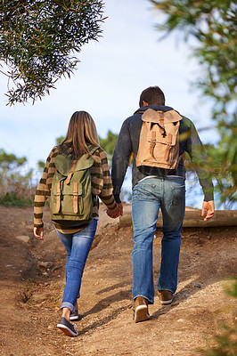 Buy stock photo Path, hiking and couple holding hands in nature for holiday, travel or adventure outdoor with backpack. Rear view, man and woman trekking in the countryside on vacation, journey and date together