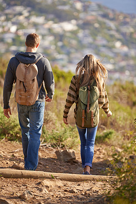Buy stock photo Vacation, hiking and couple walking in nature for holiday, travel or adventure outdoor with backpack. Rear view, man and woman trekking in the countryside on journey, date and exploration together