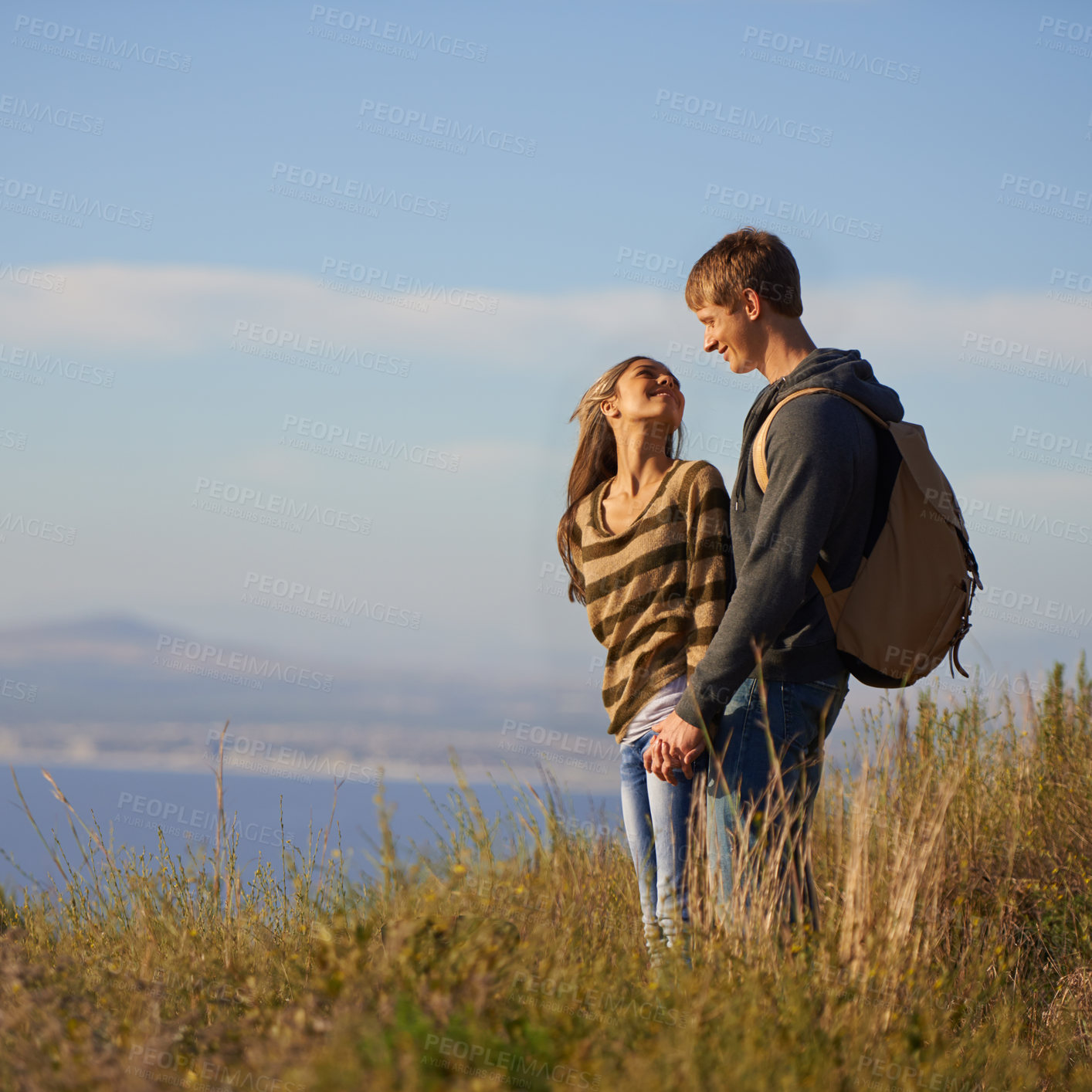 Buy stock photo Smile, hiking and couple holding hands in nature for holiday, travel or adventure outdoor together. Love, man and happy woman trekking in the countryside for bonding on vacation, journey and mockup