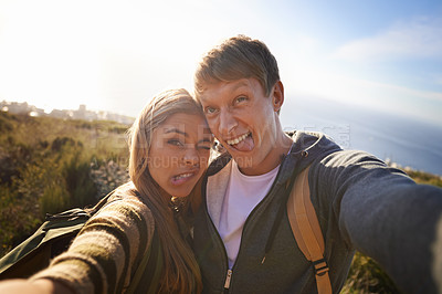 Buy stock photo Funny, face and hiking couple with selfie in nature for bonding, fun or goofy memory at sunset. Happy, love and people embrace for silly profile picture, photography or social media travel blog photo