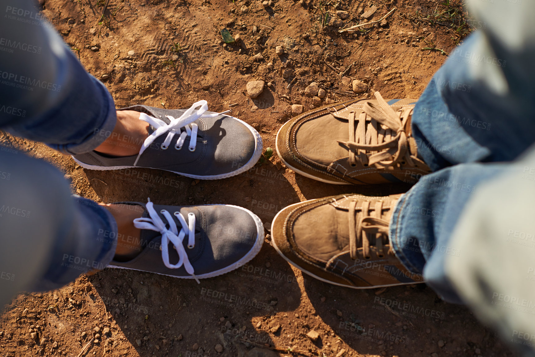 Buy stock photo Cropped high angle shot of two people standing on a dirt track