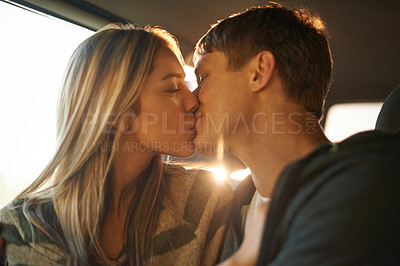 Buy stock photo Car, love and couple kiss in taxi for travel, journey or bonding on sunset road trip together. Cab, commute or people embrace on backseat with care, support or romantic moment in chauffeur transport