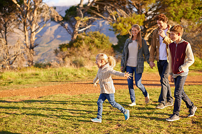 Buy stock photo Shot of a happy family out on a morning walk together