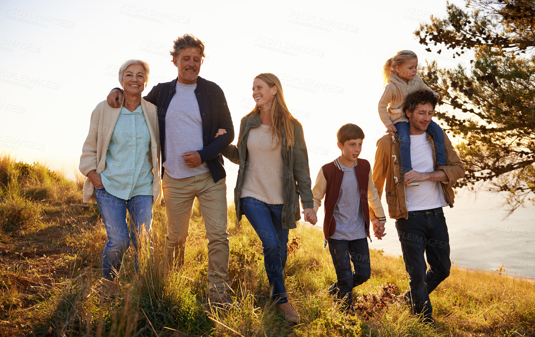 Buy stock photo Shot of a happy family out on a morning walk together