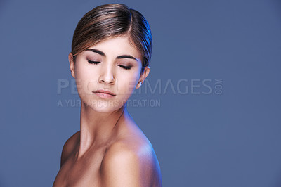Buy stock photo Beauty, face and space with natural woman in studio isolated on blue background for wellness. Aesthetic, skincare and cosmetics with confident young model on mockup for dermatology treatment