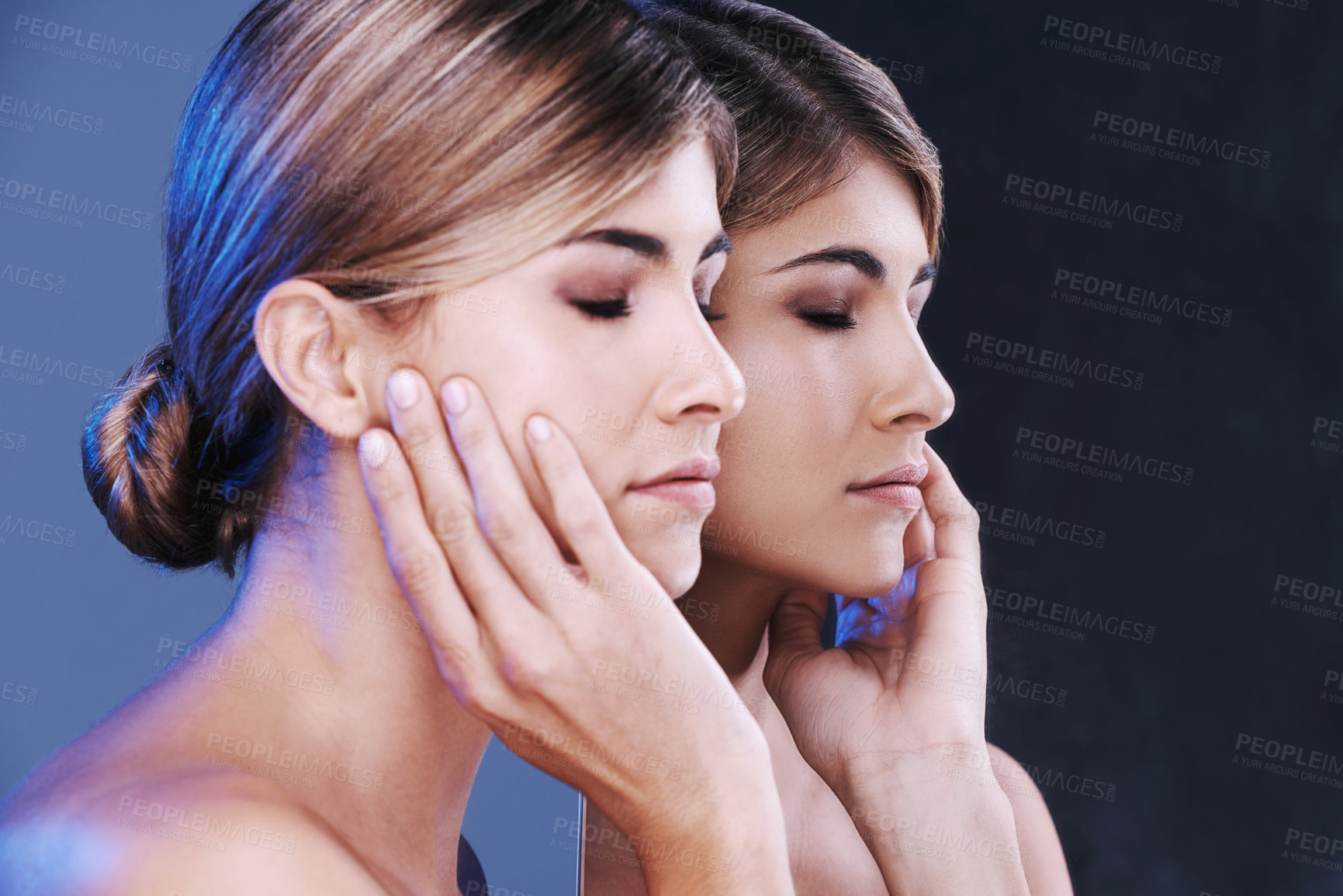 Buy stock photo Beauty, face and mirror with natural woman in studio isolated on blue background for wellness. Aesthetic, skincare and cosmetics with reflection of confident young model at spa for dermatology