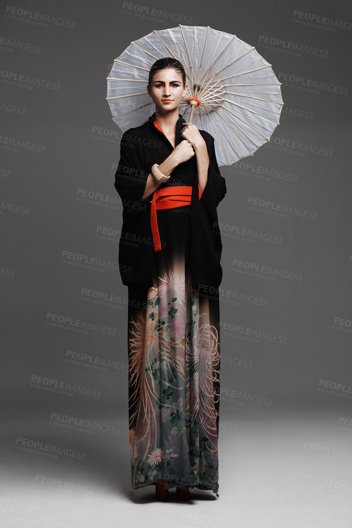 Buy stock photo Portrait, smile and Japanese woman with traditional outfit and confidence on a studio background. Person, stylish clothes and Asian with model and elegant with umbrella and proud with culture or girl