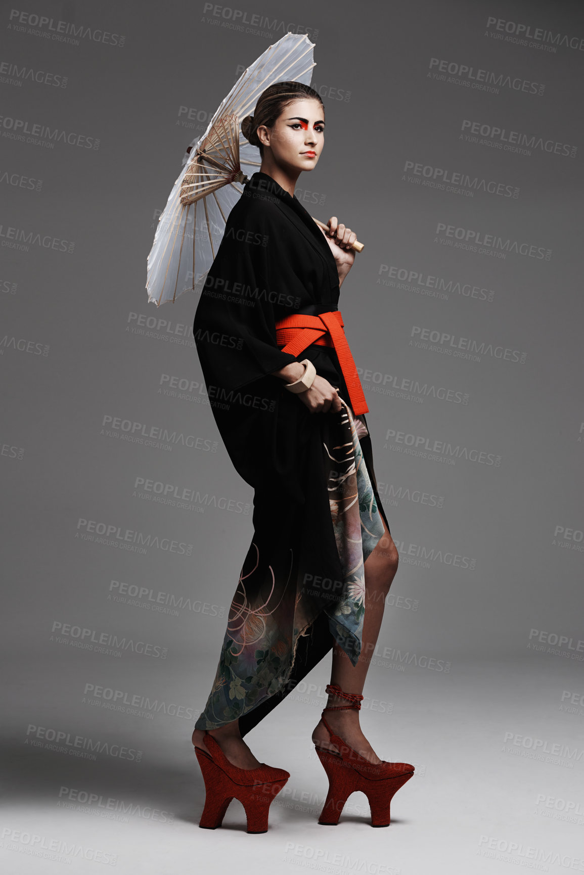 Buy stock photo Studio fashion shot of a young woman wearing oriental-style clothing