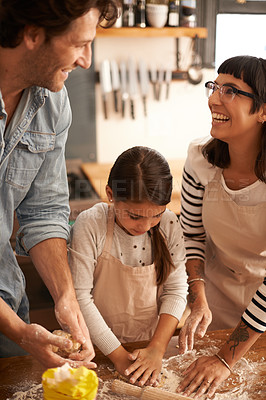 Buy stock photo Shot of a family having fun baking in a kitchen