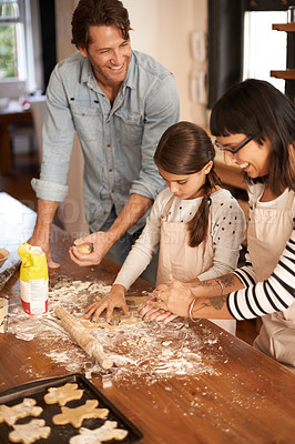 Buy stock photo Parents, kid and happy with bake biscuits in kitchen for easter season or bonding, child development and growth. Home, family and flower or dough for cookies with fun, teaching and support on holiday