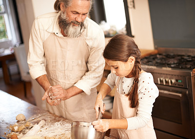 Buy stock photo Girl, child and grandfather with baking in kitchen for cooking, cookies and teaching with support and helping. Family, senior man and grandchild with mixing bowl and preparation in home with learning