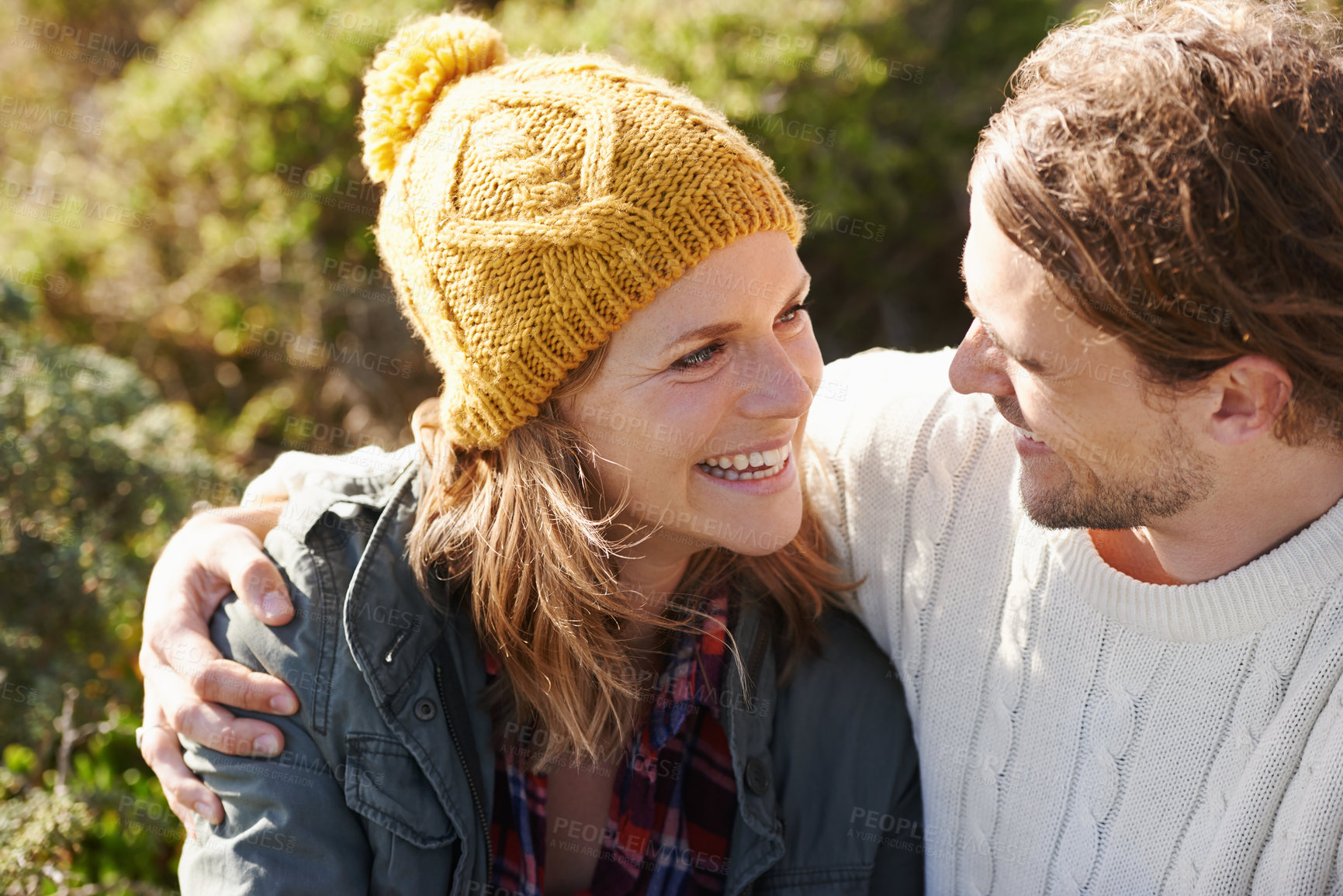 Buy stock photo Hug, outdoor and couple with love, smile and relationship with weekend break and vacation for honeymoon. Nature, romance or embrace with woman and man with sunshine or relax with holiday and marriage