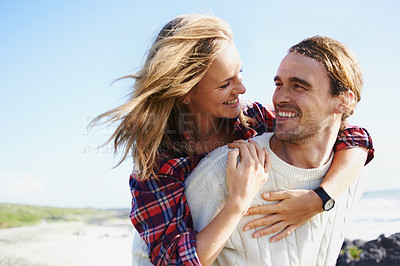 Buy stock photo Happy couple, love and bonding together in nature, piggyback and romantic getaway on holiday by blue sky. Man, woman and care on vacation on weekend break, hugging and travel in outdoor on honeymoon