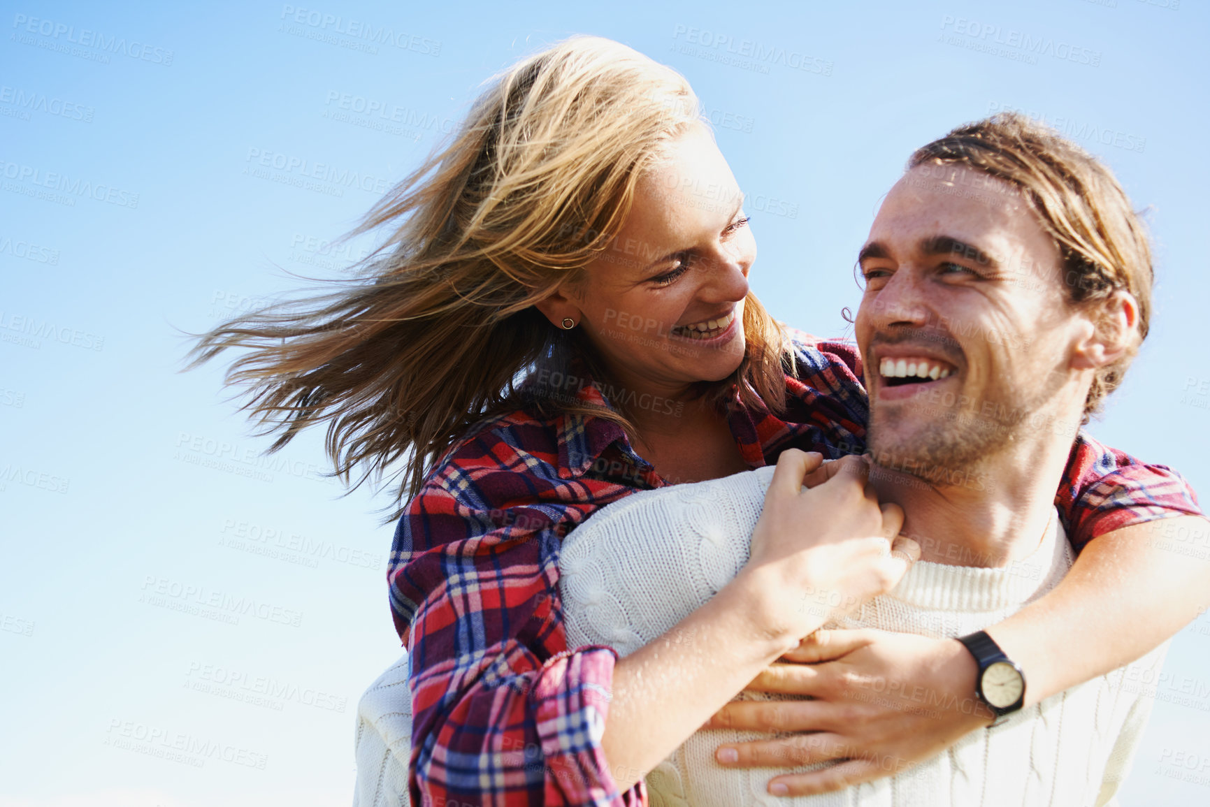 Buy stock photo Happy couple, travel and bonding together in nature, piggyback and romantic getaway on holiday by blue sky. Man, woman and love on vacation on weekend break, joy and adventure in outdoor on honeymoon