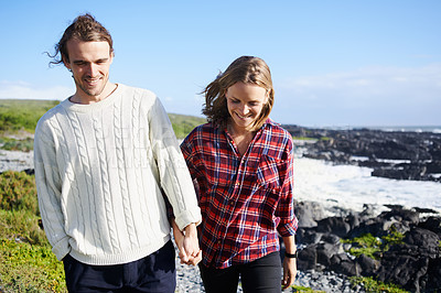 Buy stock photo Holding hands, happy and couple by ocean walking for bonding, romantic relationship and relax outdoors. Love, travel and man and woman by sea for holiday, vacation and weekend together in nature