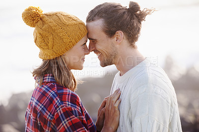 Buy stock photo Cropped shot of an attractive young couple standing face to face outdoors
