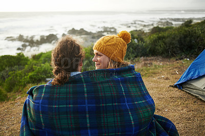 Buy stock photo Blanket, love and couple camping in nature for vacation, adventure or holiday together. Happy, conversation and young man and woman talking, bonding and relaxing by ocean on romantic weekend trip.