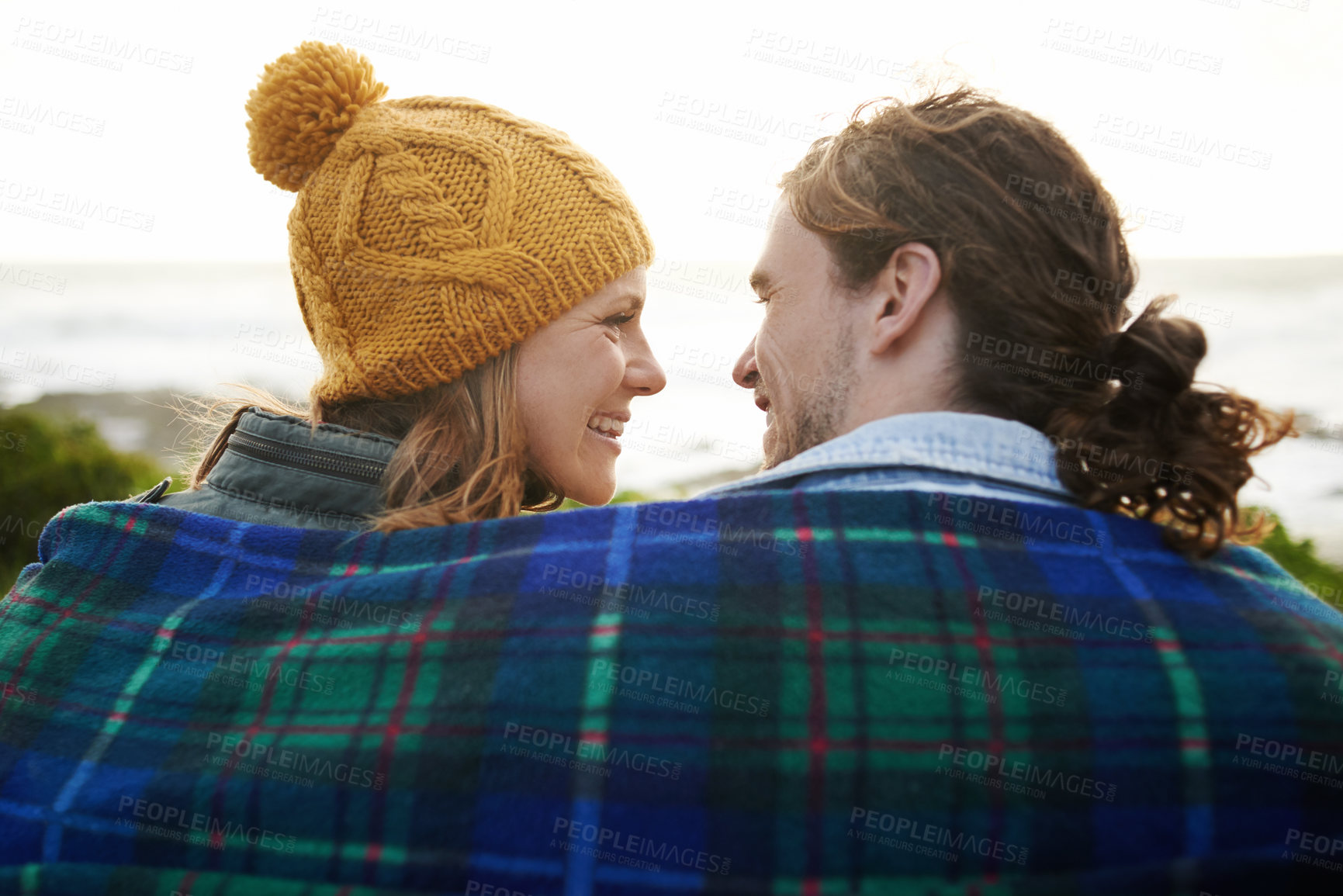 Buy stock photo Happy couple, relax and bonding together in nature, blanket and romantic getaway with camping in forest. Man, woman and love on vacation on weekend break, countryside and travel in woods for sunset