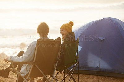 Buy stock photo Happy, camping and couple by tent on vacation, adventure or holiday in nature for travel. Smile, love and young man and woman talking, bonding and relaxing outdoor for weekend trip by seaside.