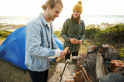 Buy stock photo Nature, happy and couple with fire for camping on romantic vacation, adventure or holiday. Smile, love and young man and woman with flame for warm on outdoor winter weekend trip with tent together.