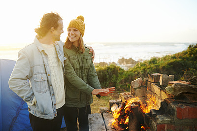 Buy stock photo Nature, love and couple with fire for camping on romantic vacation, adventure or holiday. Happy, smile and young man and woman with flame for warm on outdoor winter weekend trip with tent together.