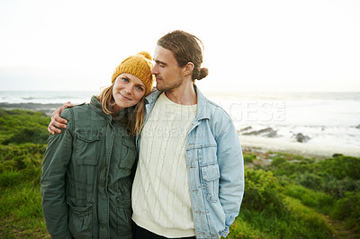 Buy stock photo Hug, love and portrait of couple by ocean in winter for bonding, romantic relationship and relax outdoors. Nature, travel and happy man and woman by sea for holiday, vacation and weekend together
