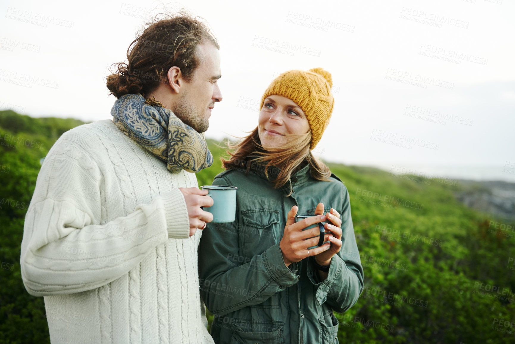 Buy stock photo Cropped shot of an affectionate young couple enjoying the outdoors