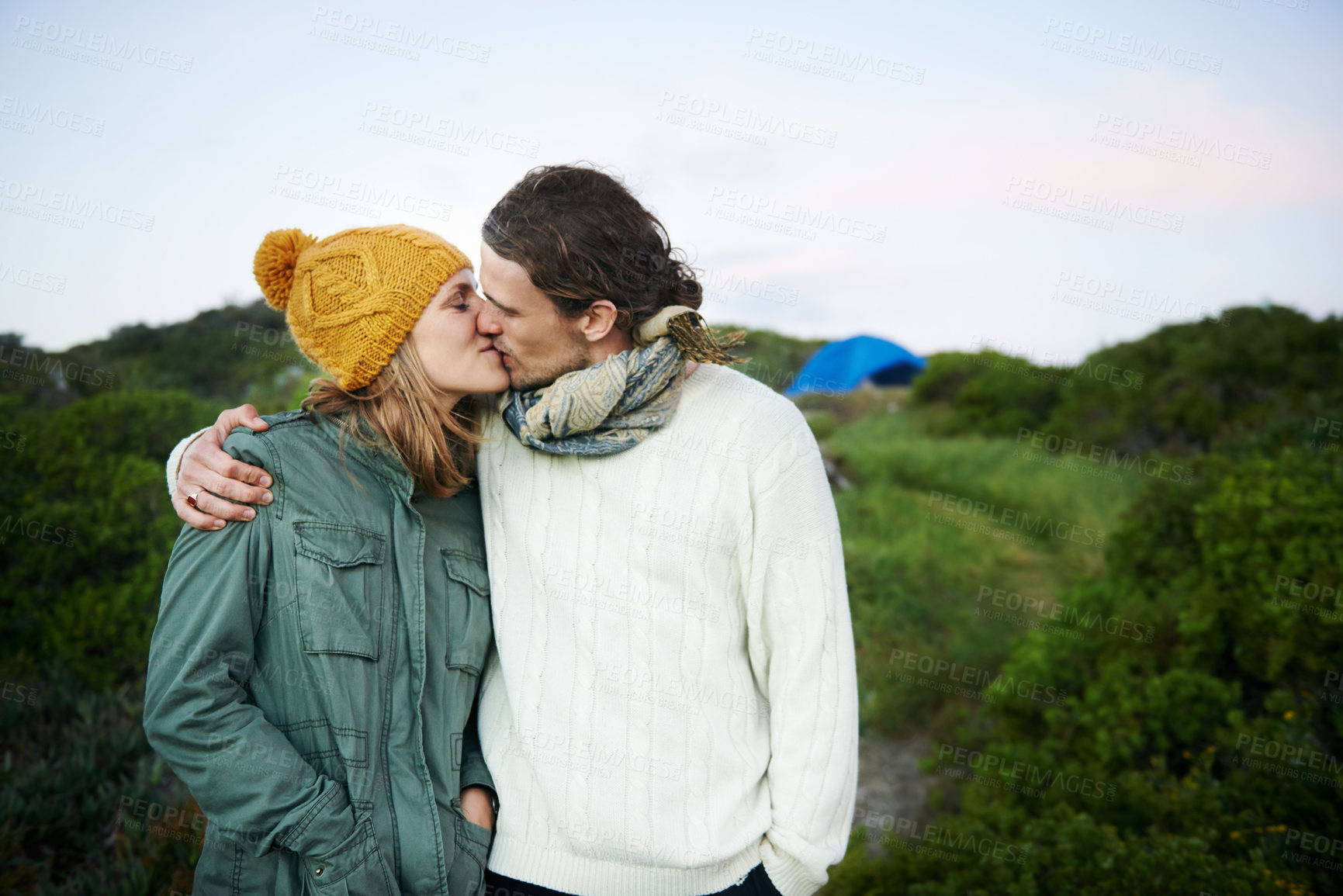 Buy stock photo Date, camping and couple with love, kiss and hug with happiness and vacation for honeymoon. Romance, nature and man with woman and embrace with holiday and bonding together with adventure and smile