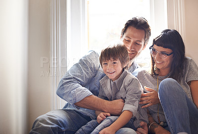 Buy stock photo A mother and father sitting with their son