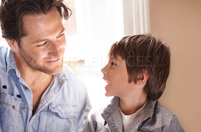 Buy stock photo Dad, boy and smile conversation in home, happy son and man bonding for child development and paternal relationship. Kid, family vacation house and male person listening or discussion on Fathers day