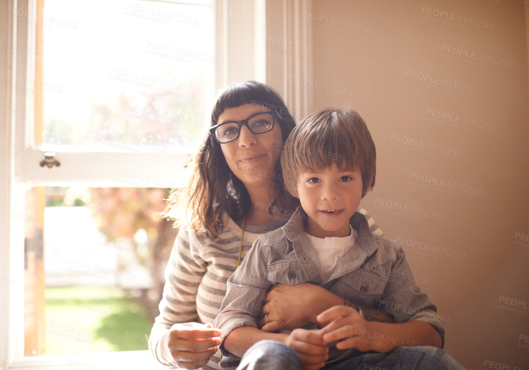 Buy stock photo A little boy sitting with his mother