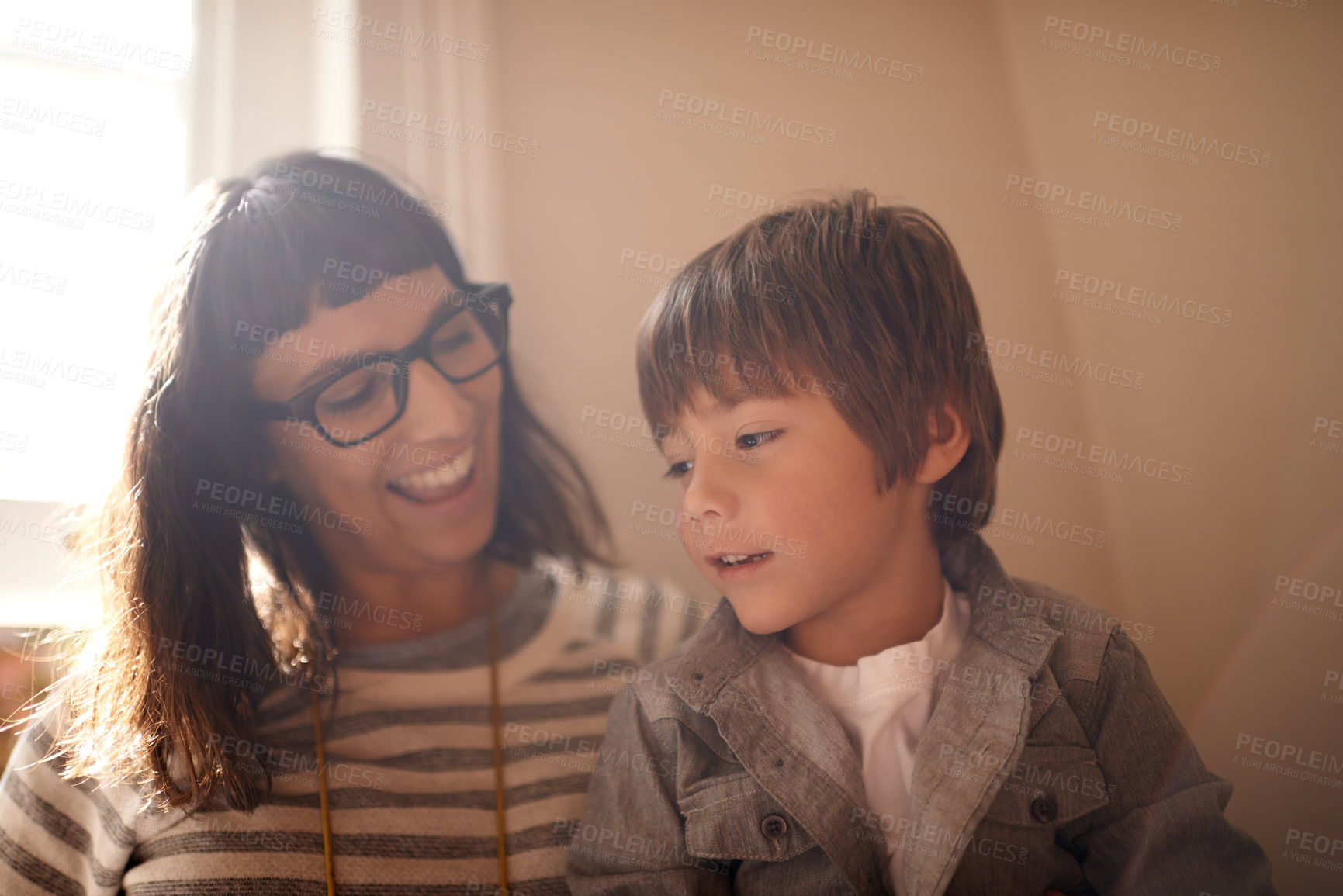 Buy stock photo Home, relax and family with mother, son and conversation with happiness and bonding together. Single parent, son and kid with mama and discussion with joke and funny with humor, smile and laughing
