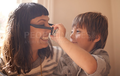 Buy stock photo Remove glasses, mother and son with smile, funny and family with happiness and cheerful in a lounge. Single parent, mama and kid with childhood and take off eyewear with joy and humor with laughing