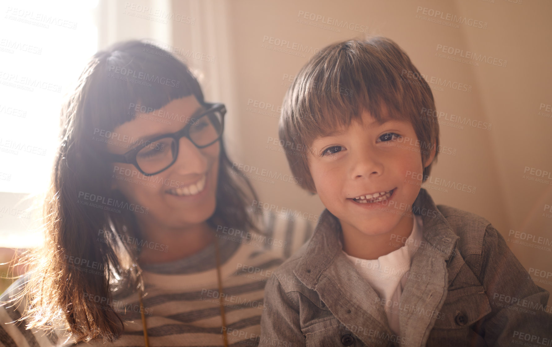 Buy stock photo A little boy sitting with his mother