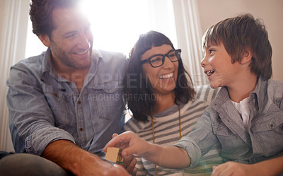 Buy stock photo A mother and father sitting with their son