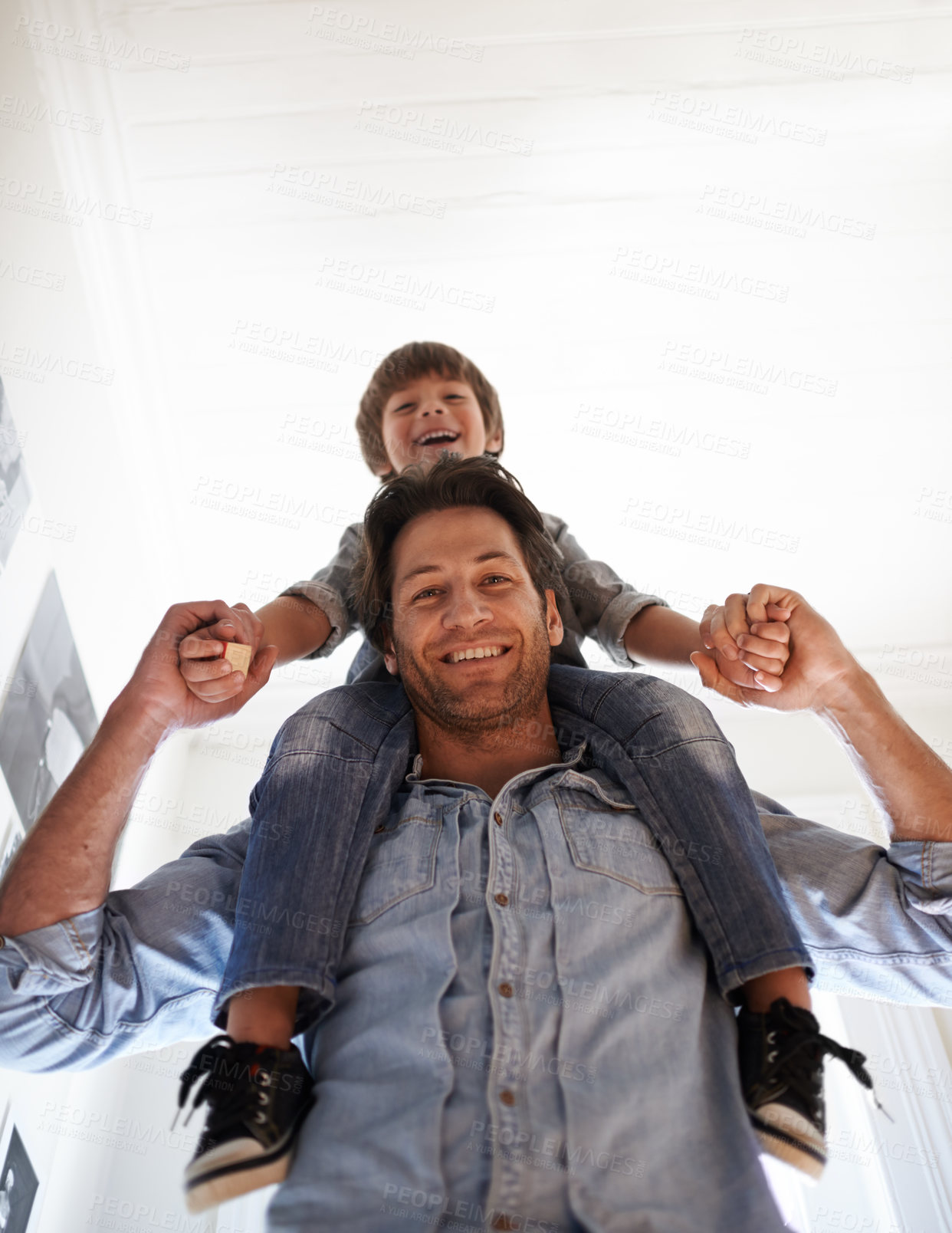 Buy stock photo Piggyback, portrait or father with child in home, house or apartment for support, care or love. Happy, low angle or dad with kid to enjoy family vacation, holiday or holding hands together in England