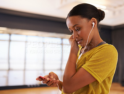Buy stock photo Sound, music and dancer listening with earphones connect on digital device in studio or gym in weekend. Audio, female person and woman streaming songs on app to relax with technology for girl