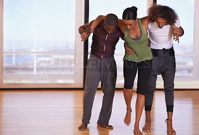 Buy stock photo Shot of a group of people practicing in a dance studio
