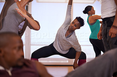 Buy stock photo Black woman, yoga and stretching body with team in class for workout, exercise or indoor training together. African female person, coach or instructor in warm up with group in fitness for wellness