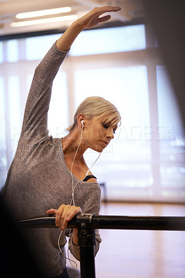 Buy stock photo Earphone, ballet and woman with body stretch in dance studio for performance, show or theater rehearsal. Art, balance or dancer with stretching pole for ballroom, fitness or warm up stage training