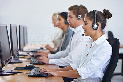 Buy stock photo Shot of a client services team fielding phonecalls