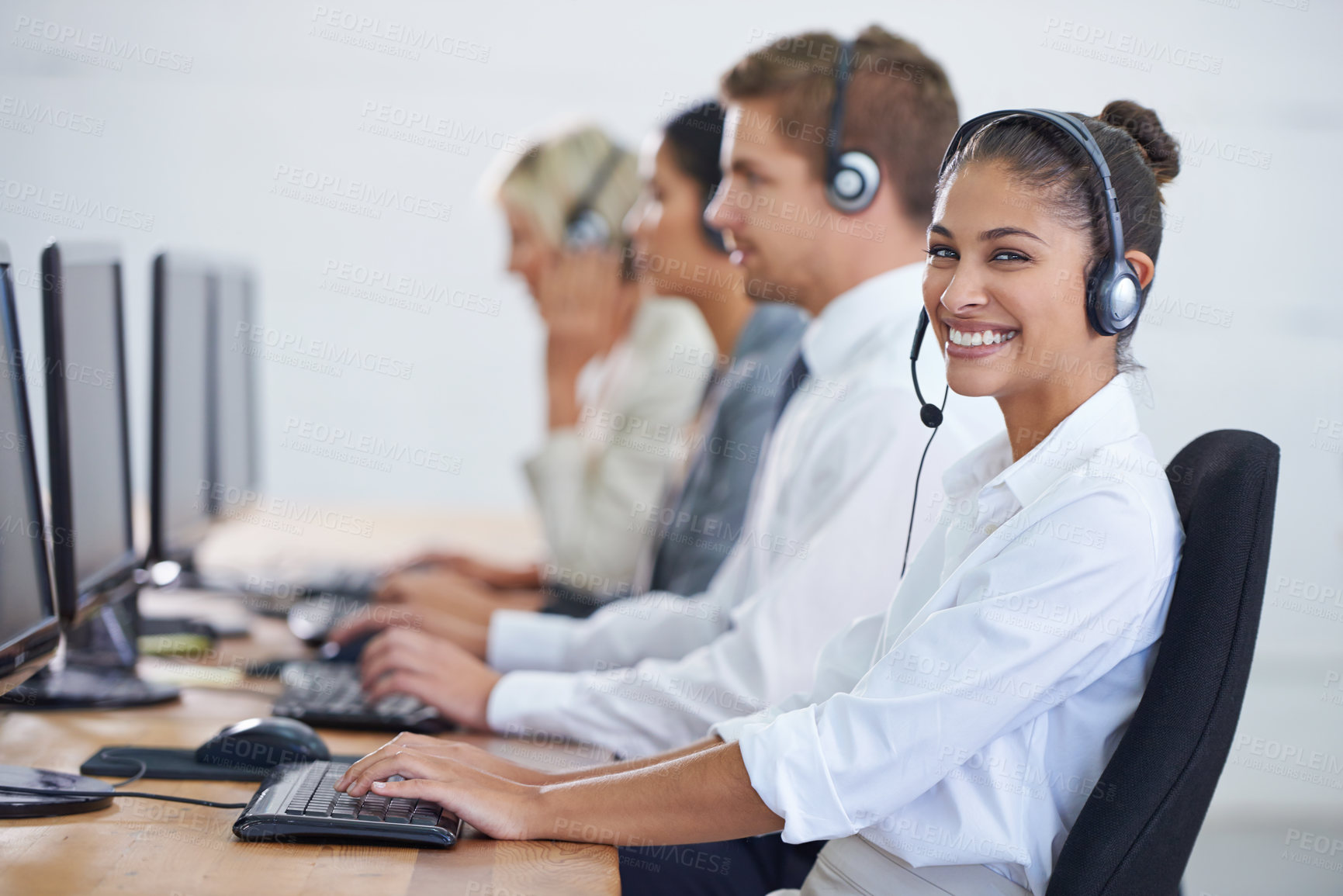 Buy stock photo Callcenter, portrait and phone call with woman, typing on computer and consultant at customer support. Headset, telemarketing and client service agent at help desk with teamwork in coworking space	