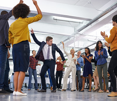 Buy stock photo Shot of a businessmen dancing in the centre of a circle of coworkers