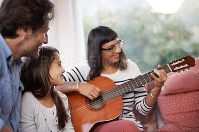 Buy stock photo Woman, music and playing guitar for family at home, relaxing and enjoying together on couch. Performance, father and child with mother in living room, entertainment and happy with musical instrument