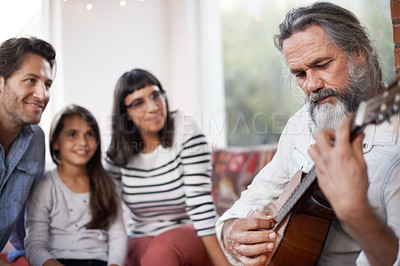 Buy stock photo Mature man, music and playing guitar for family at home, relaxing and enjoying together on sofa. Performance, parents and child with grandfather in living room for entertainment with instrument