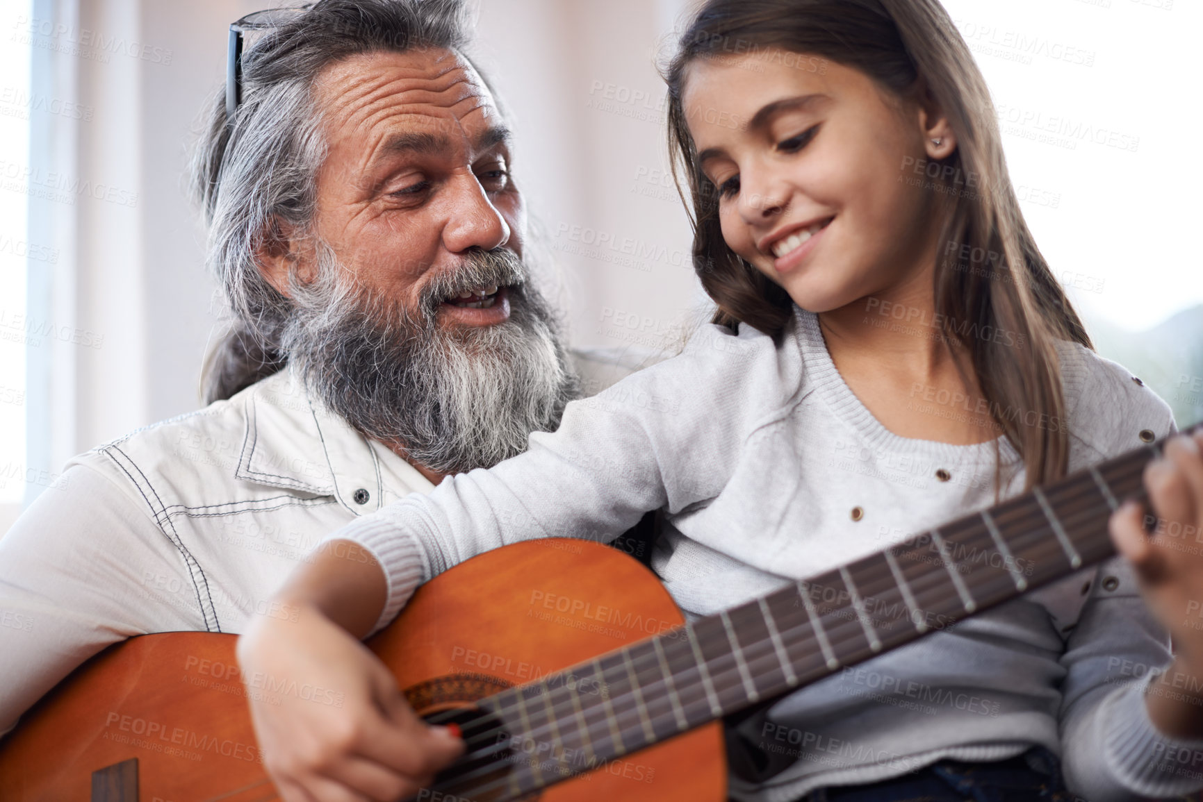 Buy stock photo Girl with grandfather, happy with guitar and learning to play, music education and creative development. Musician, art and old man helping female kid learn focus and skill on musical instrument