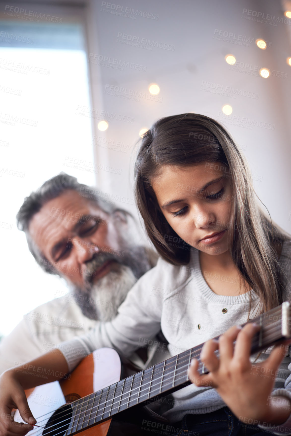 Buy stock photo Girl with grandfather, guitar and learning to play, music education and help with creative development. Musician, art and old man helping female kid learn focus and skill on musical instrument