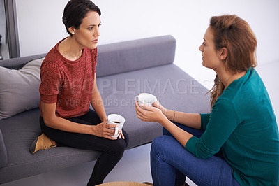 Buy stock photo Shot of two female professionals having a discussion in an informal office setting